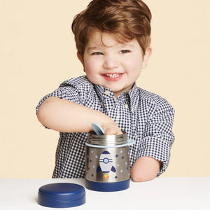 A boy is eating food from the food jar