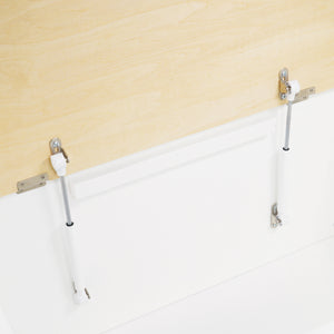 Metal bed railings on a white bed against a beige wall.