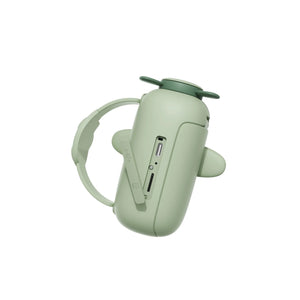 Close-up of dino zoo video camera with wrist strap, charging connector and memory card slot.