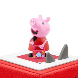 Peppa Pig Tonie figure standing magnetically on the top surface of a red Toniebox audio player against a plain white background.