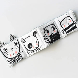 Close-up of cat, dog, bunny, owl, and bee characters in cloth book.