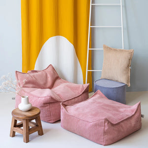 The beanbag chair is nicely decorated in a room.