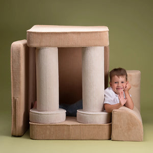 A boy is playing with Wigiwama sofa set in brown sugar settee