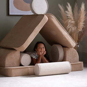 A girl is playing with Wigiwama sofa set.