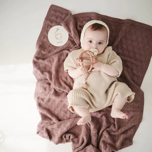 Newborn baby swaddled in beige Knitted Blanket