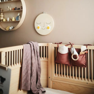 The mushie blanket provides warmth and comfort.