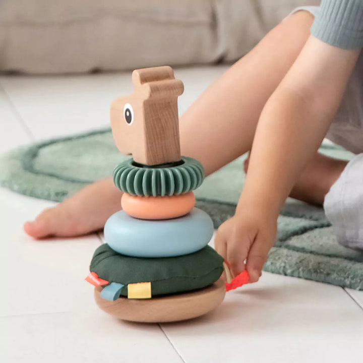 child playing with stacking toy