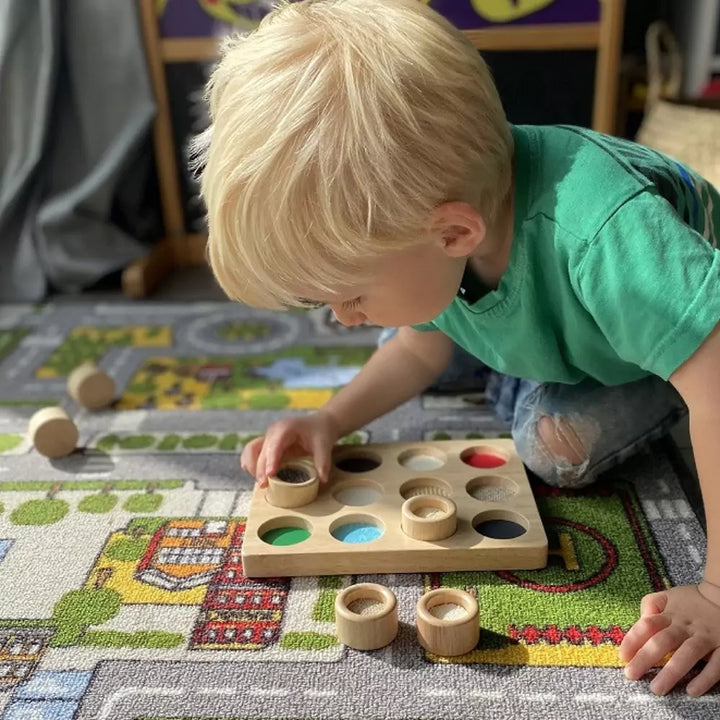 Child playing with wooden board game