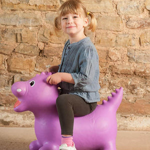 A girl is playing with the Happy Hopperz toy