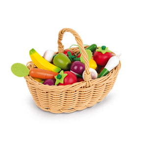 A basket filled with various toy fruits and vegetables, including bananas, apples, oranges, strawberries, mushrooms, carrots, radishes, tomatoes, and leeks.