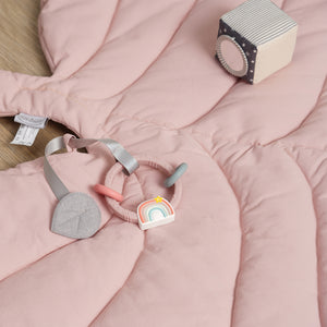 Baby play mat in pink leaf design for newborns.