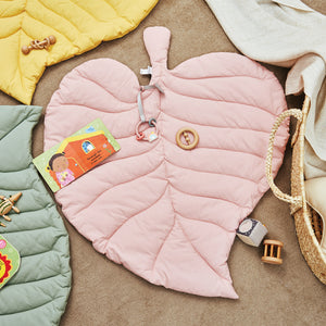 Pink play mat with sensory toys including mirror and teether.