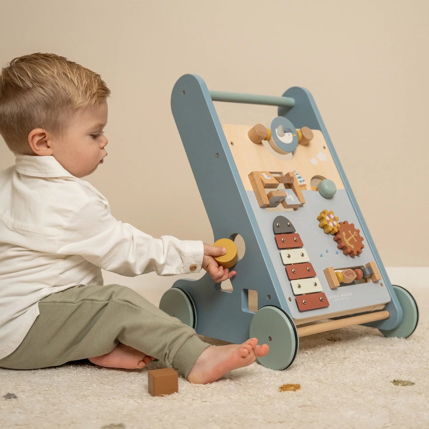 Kid playing with little dutch wooden baby walkers