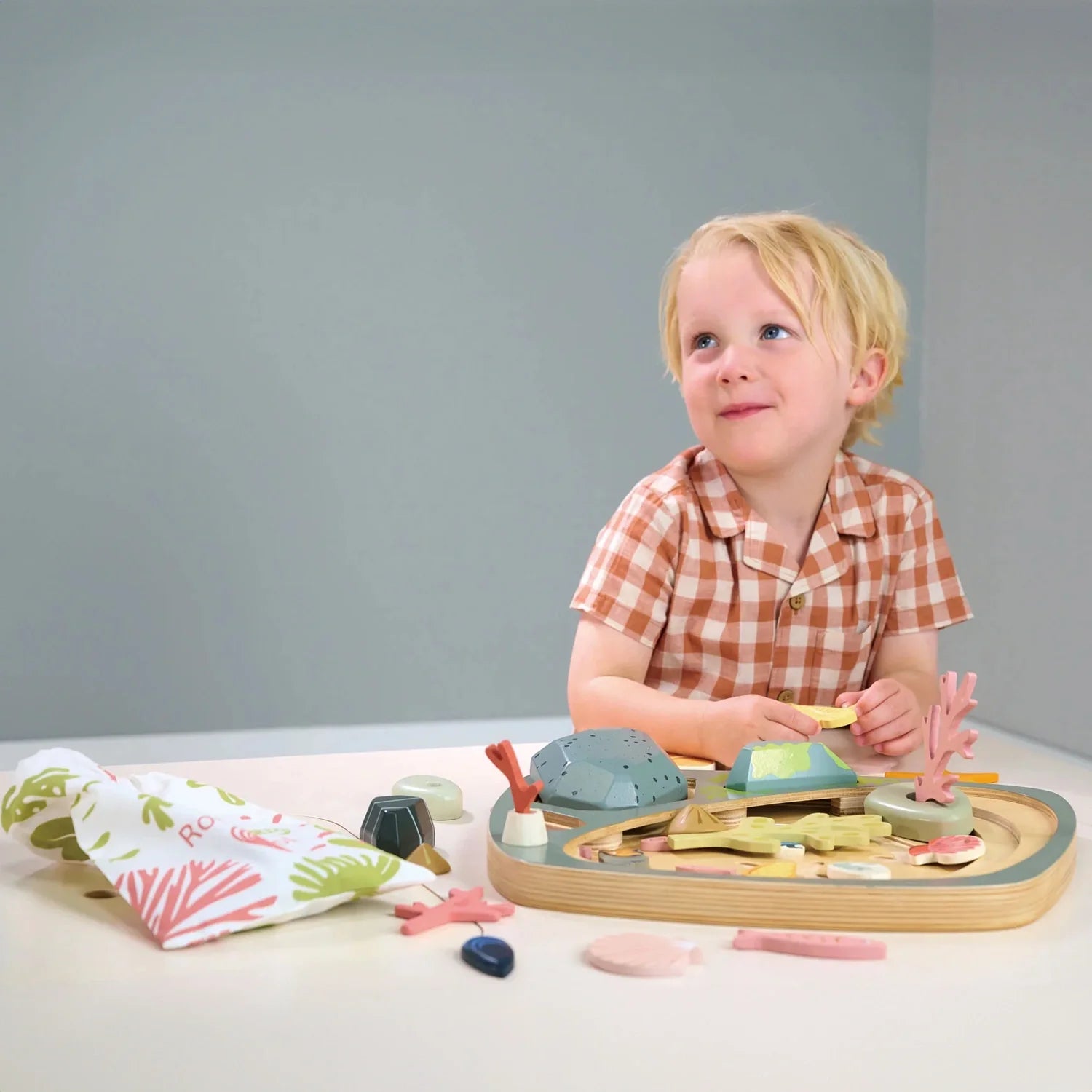Toddler playing with tender leaf kids toys.