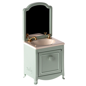 Bathroom vanity with mirror and sink on a white background
