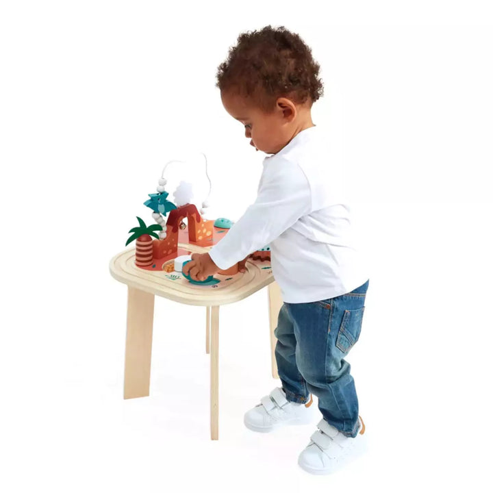 A boy is playing with activity table in white background