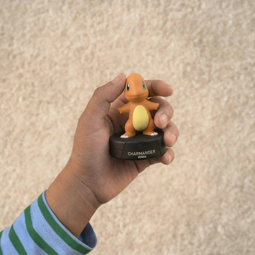 A boy is holding the Tonies Pokemon Charmander