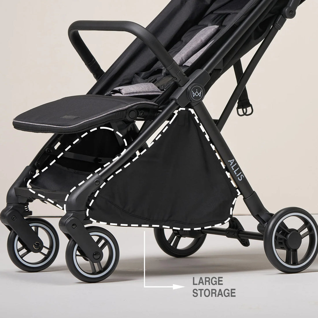Black stroller with large storage compartment on a beige background