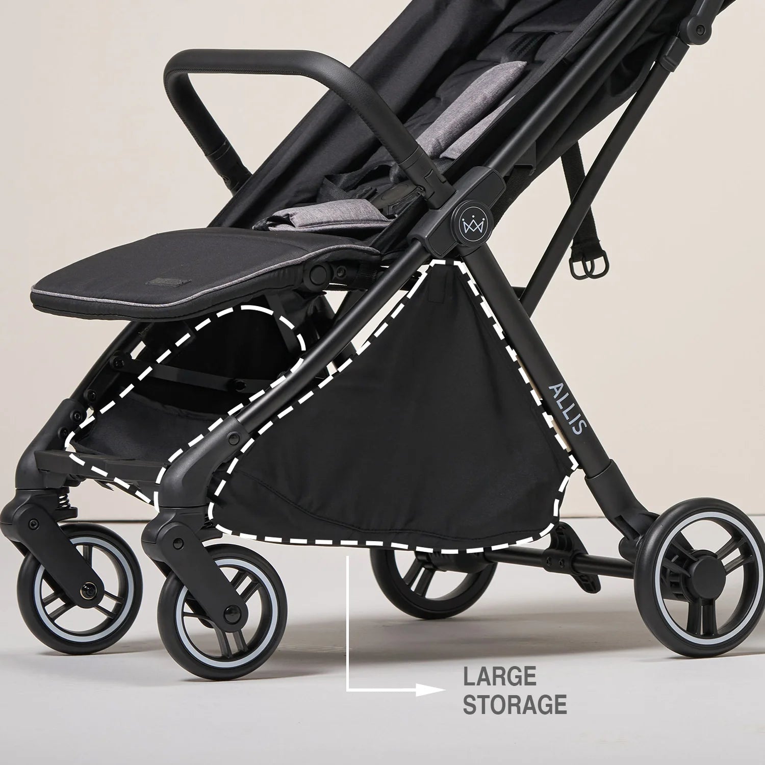 Black stroller with large storage compartment on a beige background