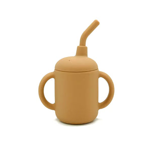 Front view of mustard yellow silicone sippy cup featuring two easy-grip handles and a flexible straw.