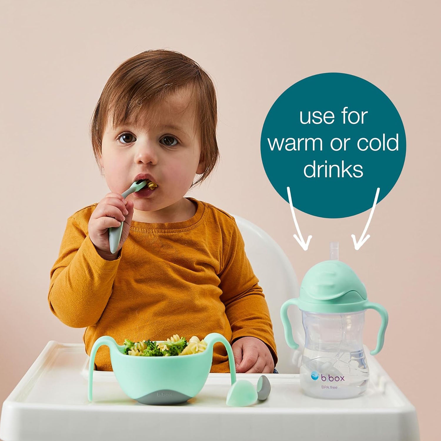 A toddler is having food and drinking water with B.box sippy cup.