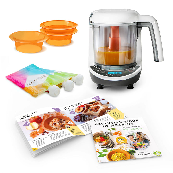 Baby Brezza Food Maker Deluxe with a steaming bowl, blending blades, and control panel.