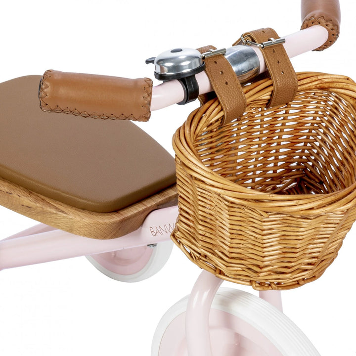 Close-up of the Banwood Trike's pink frame and wicker basket