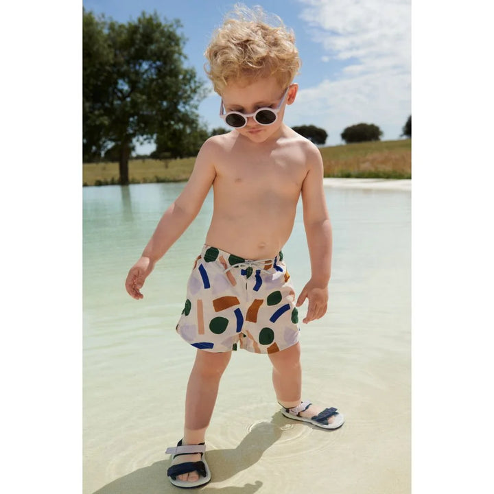Boy Wearing UV Protected Sunnies on the beach by Liewood Darla