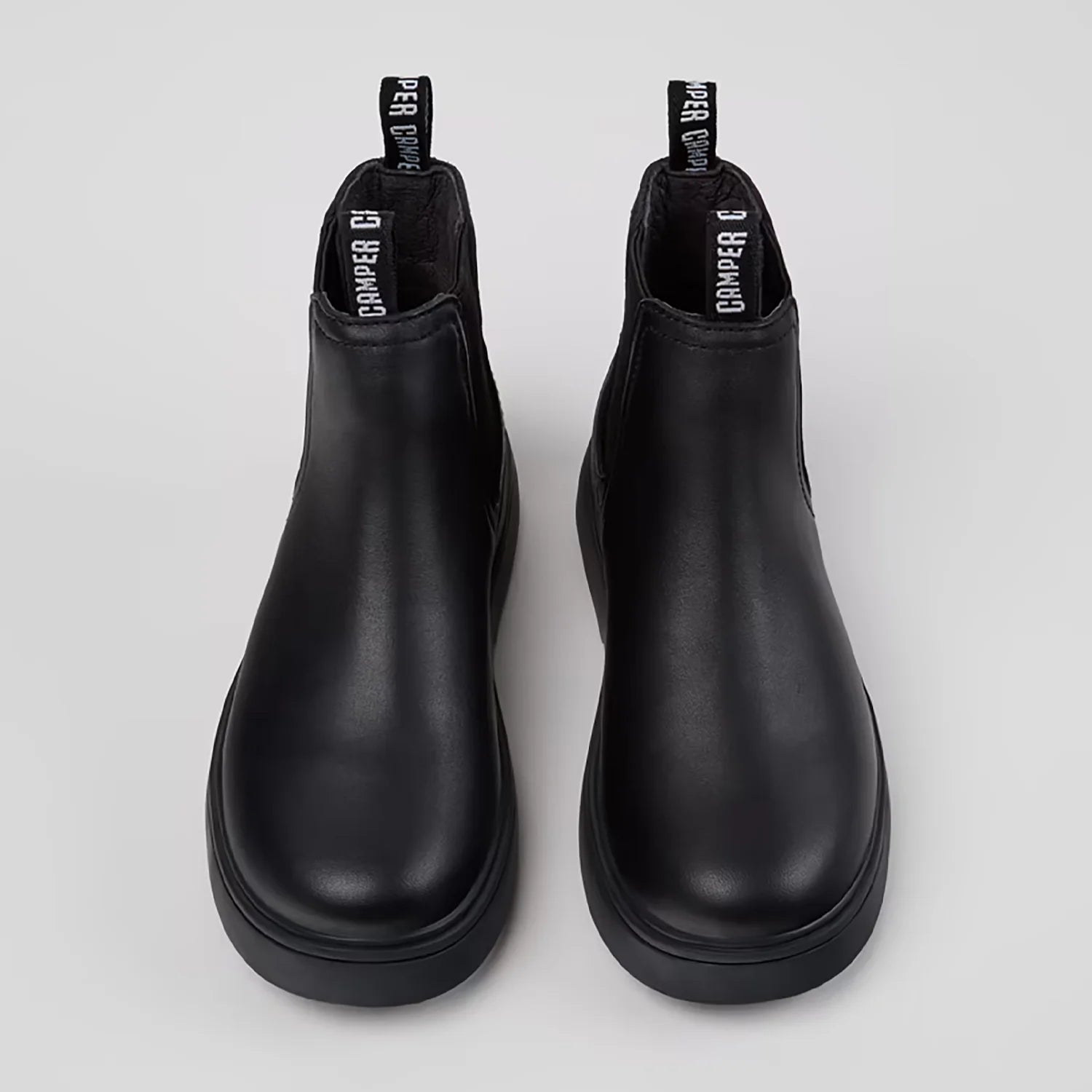 Durable rubber outsole of Camper black leather ankle boots for kids.