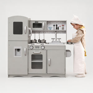 Young toddler playing with the deluxe grey wooden toy kitchen set.
