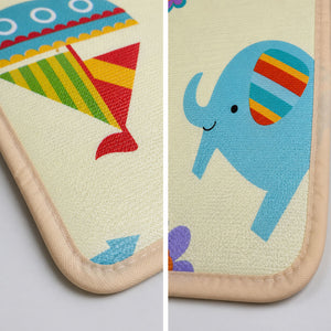 Close-up detail showing the crisp printed graphics of an elephant and a plane, along with the durable stitched edging of the Allis Play Mat.