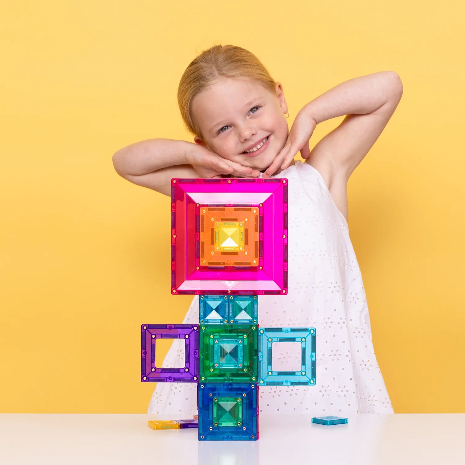 Kids building creative structures with magnetic tiles