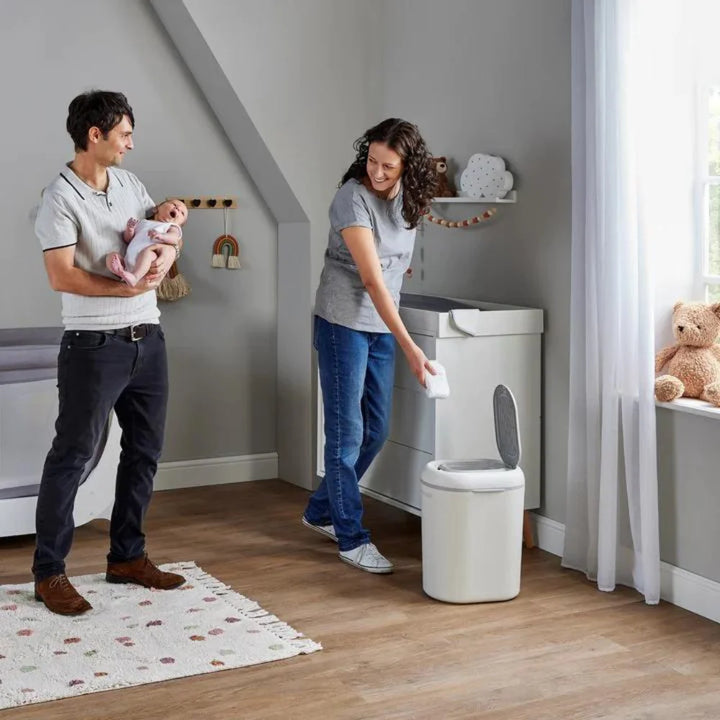 Couple using eco touch baby nappy bin in nursery Shnuggle