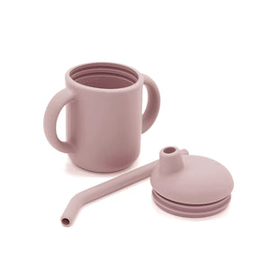 Disassembled blush pink silicone toddler cup displaying the cup body, lid, and straw.