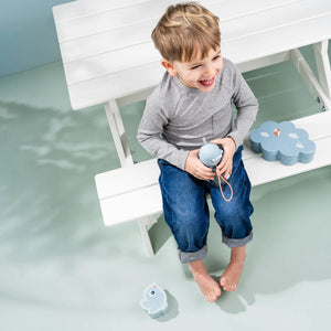 A kid is holding Done by Deer water bottle