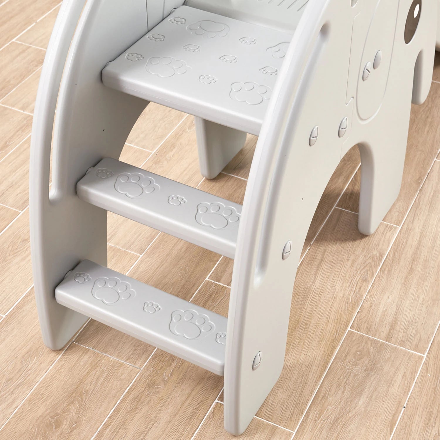 Close-up of the elephant slide's steps, showing their non-slip surface and sturdy sidewalls.
