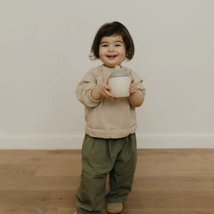 A girl is holding the Elhee silicone bubble bottle.
