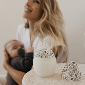 Parent using anti-colic baby bottle for calm feeding experience