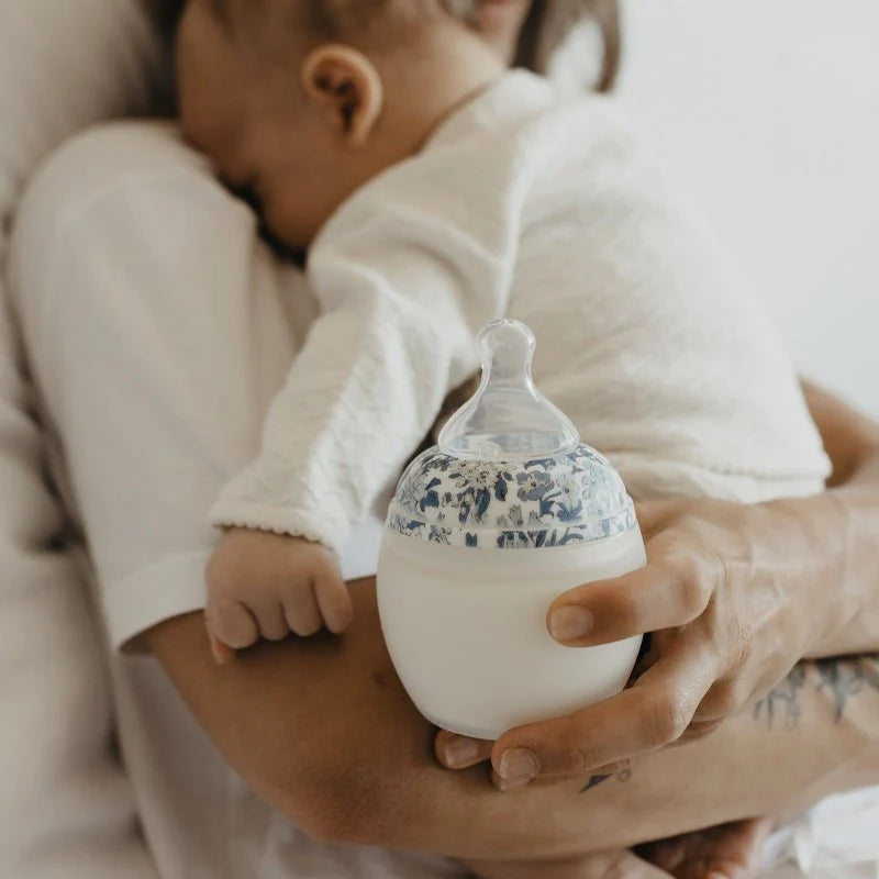 Safe and gentle bottle-feeding moment between parent and baby