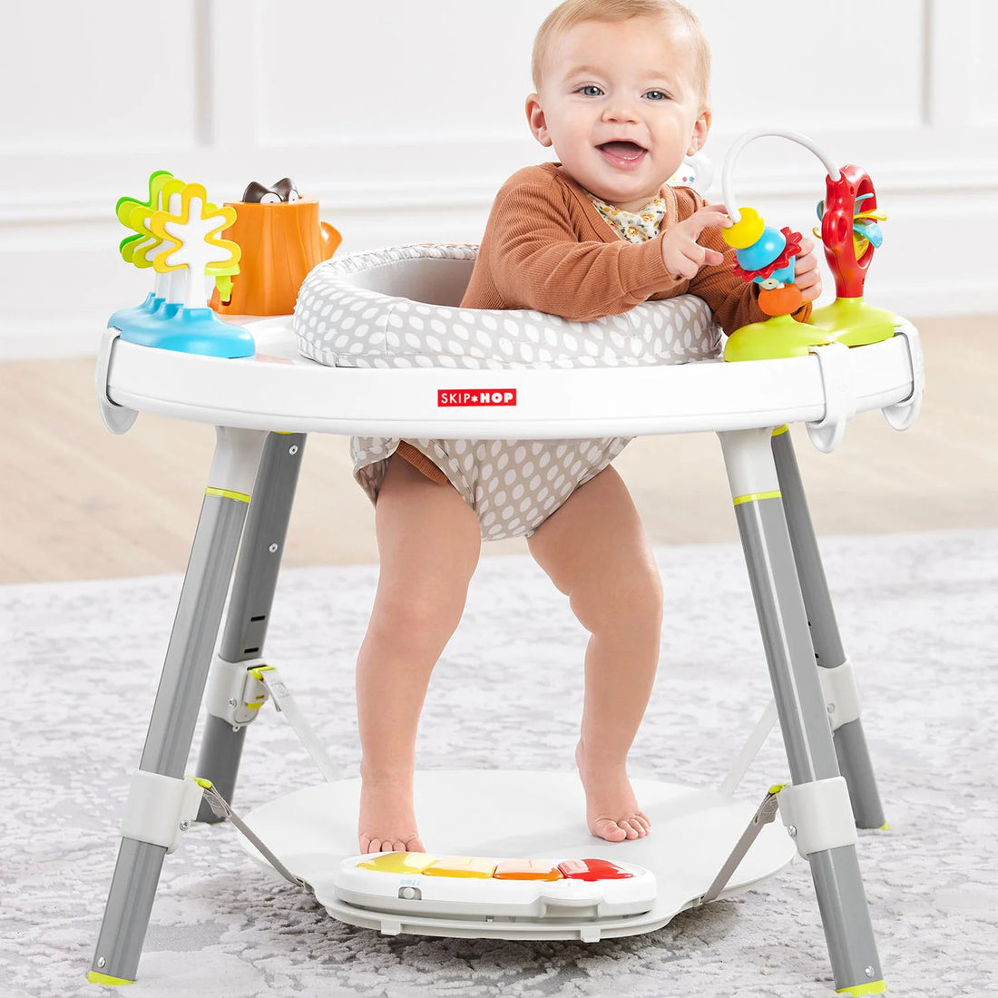 Baby's View 3-Stage Activity Center with rotating seat and activity panel.