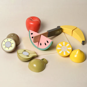 Children slicing wooden fruit with a toy knife from the Wooden Fruit Toys set.
