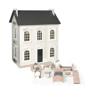 Wooden dollhouse with furniture on a white background