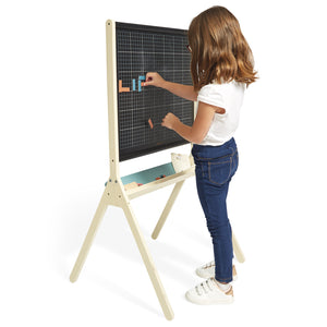 A girl is using Magnetic board to draw
