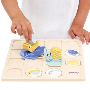  A young child matching snail parts on the board while developing problem-solving skills.