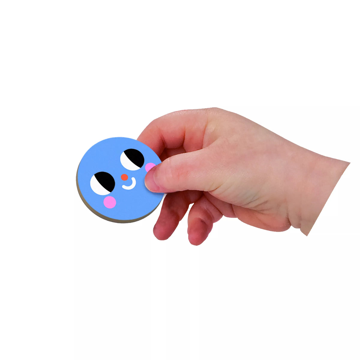 Child’s hand placing a blue circular magnetic shape onto Janod Magnetibook play surface
