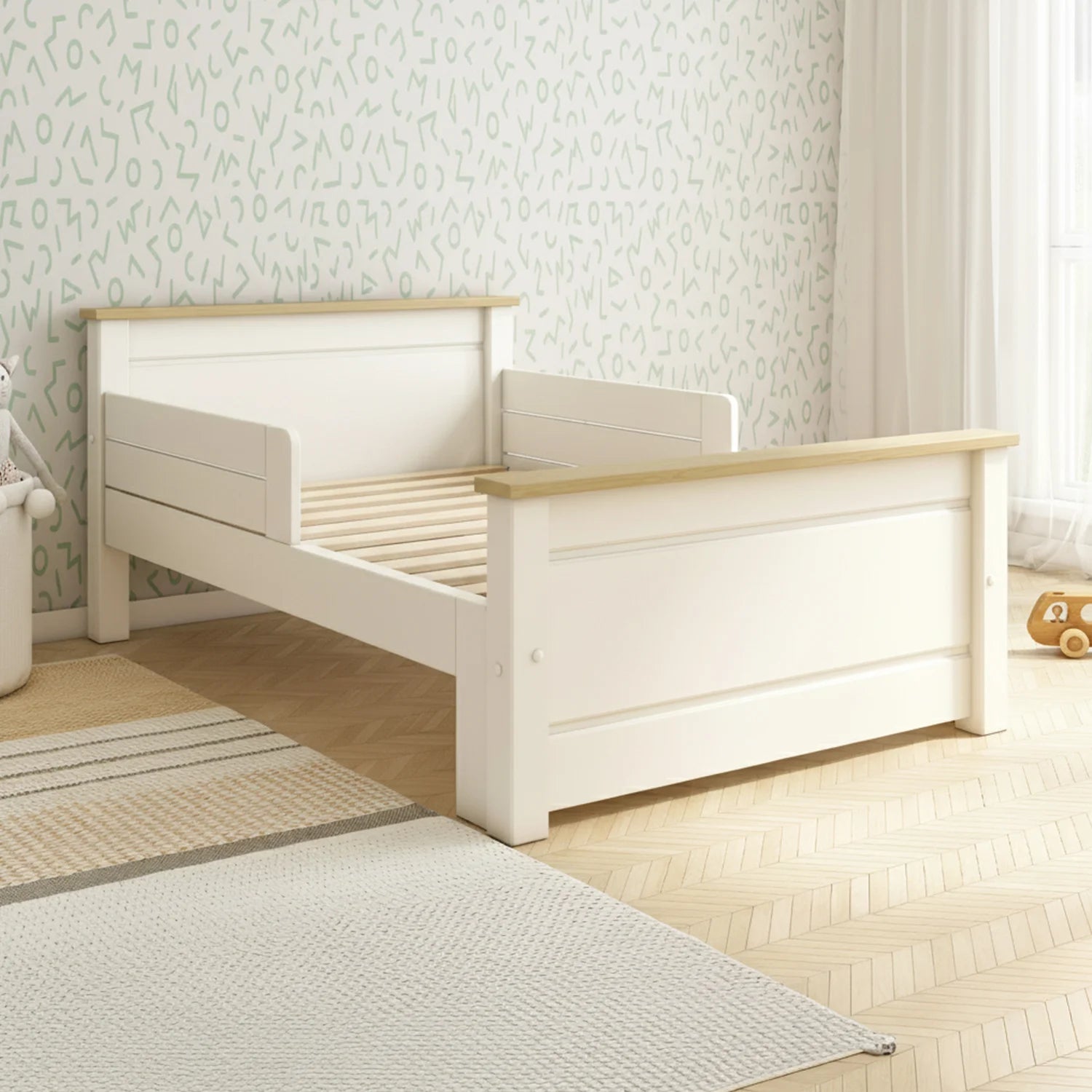 White and wood children's bed in a room with light-colored walls and flooring.