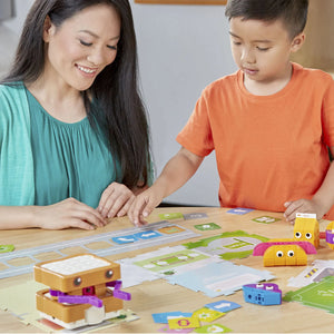 Mom and boy working together to lay down code cards for a Sammy the Sandwich Robot program.