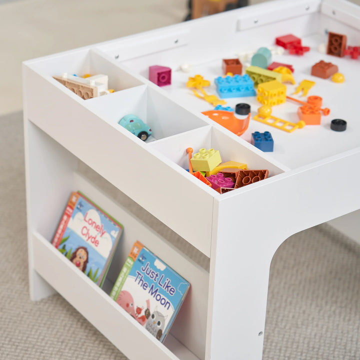 A white Activity Table with colourful toys and books scattered across the surface, creates a fun and inviting play space.