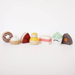 Sweet treats on a beautifully crafted wooden cake stand.
