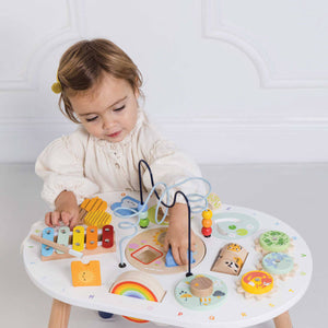 Child exploring textures and shapes on the sensory activity table
